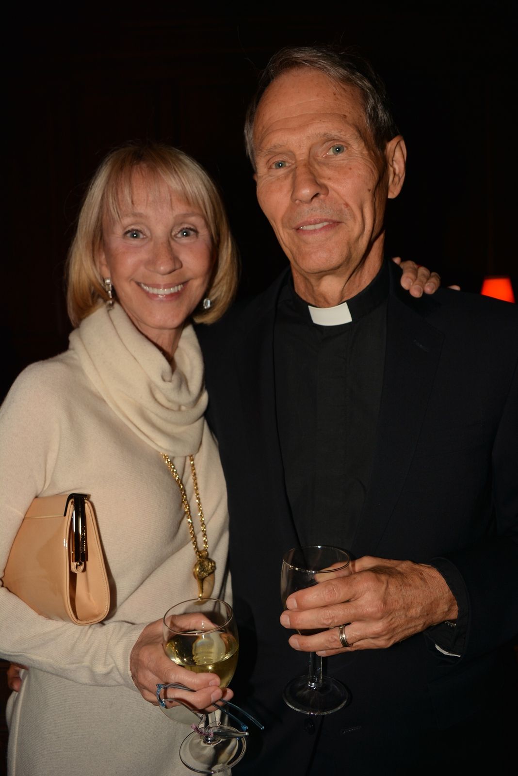 Two guests standing together, one wearing a clerical collar.