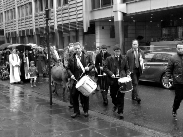 Musicians leading the Palm Sunday procession towards the camera.