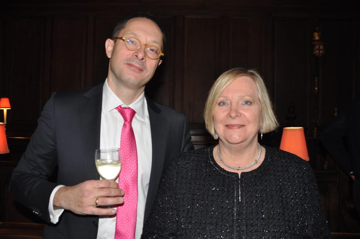 Two guests posing together, one wearing a bright pink tie.