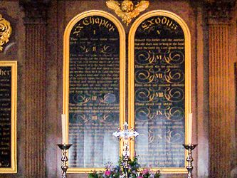 A panoramic detail of the altar screen and flower arrangements.