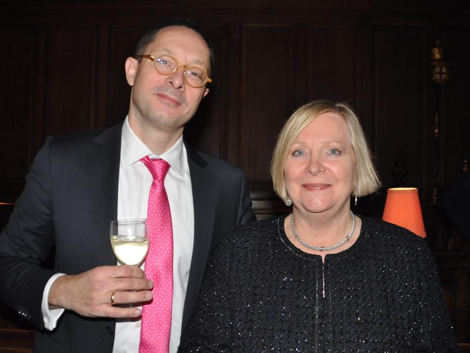 Two guests posing together, one wearing a bright pink tie.