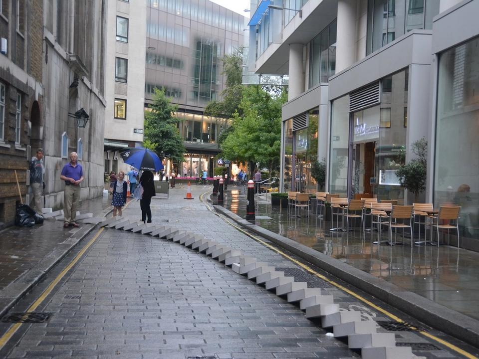 Fallen white blocks stretching along a city street.