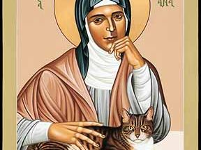 An icon of Julian of Norwich with a cat and writing materials.