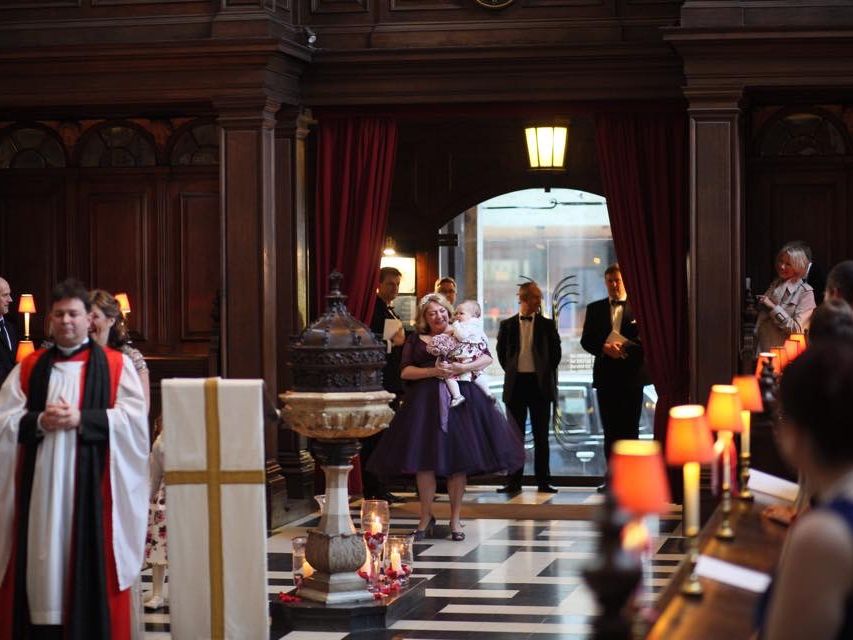A wedding party arriving through the open church doorway.