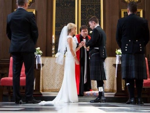 A wedding ceremony seen from a low viewpoint along the patterned floor.