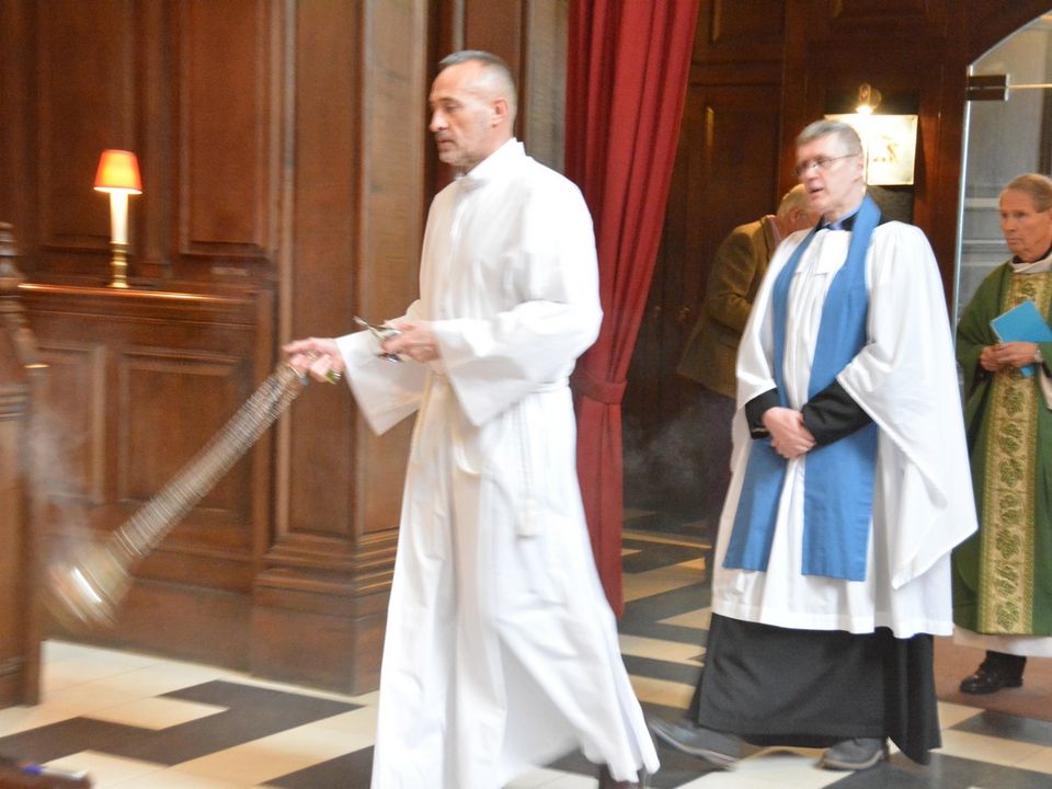 Clergy processing through the church with candles and incense.
