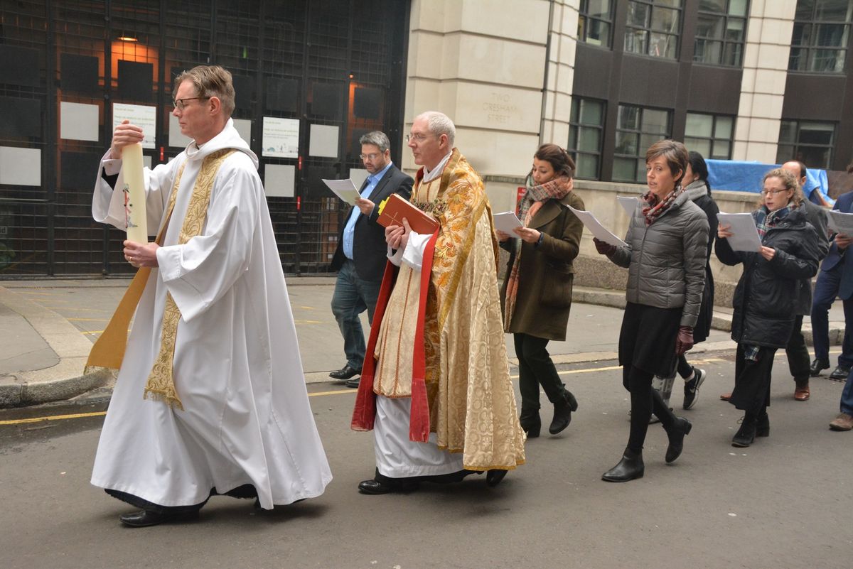 Clergy and worshippers processing along the street outside the church.