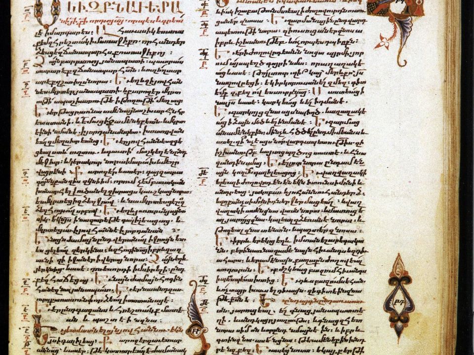 An illuminated manuscript page with two columns of text and painted figures.