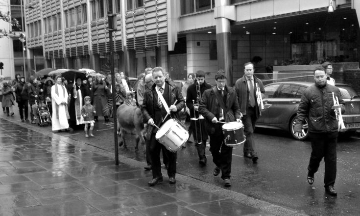Musicians leading the Palm Sunday procession towards the camera.
