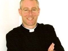 A portrait of the Revd Jonathan Herapath with his arms folded.