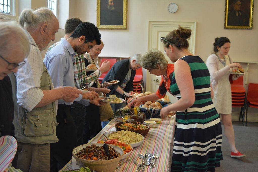 Guests serving themselves from a long buffet table.