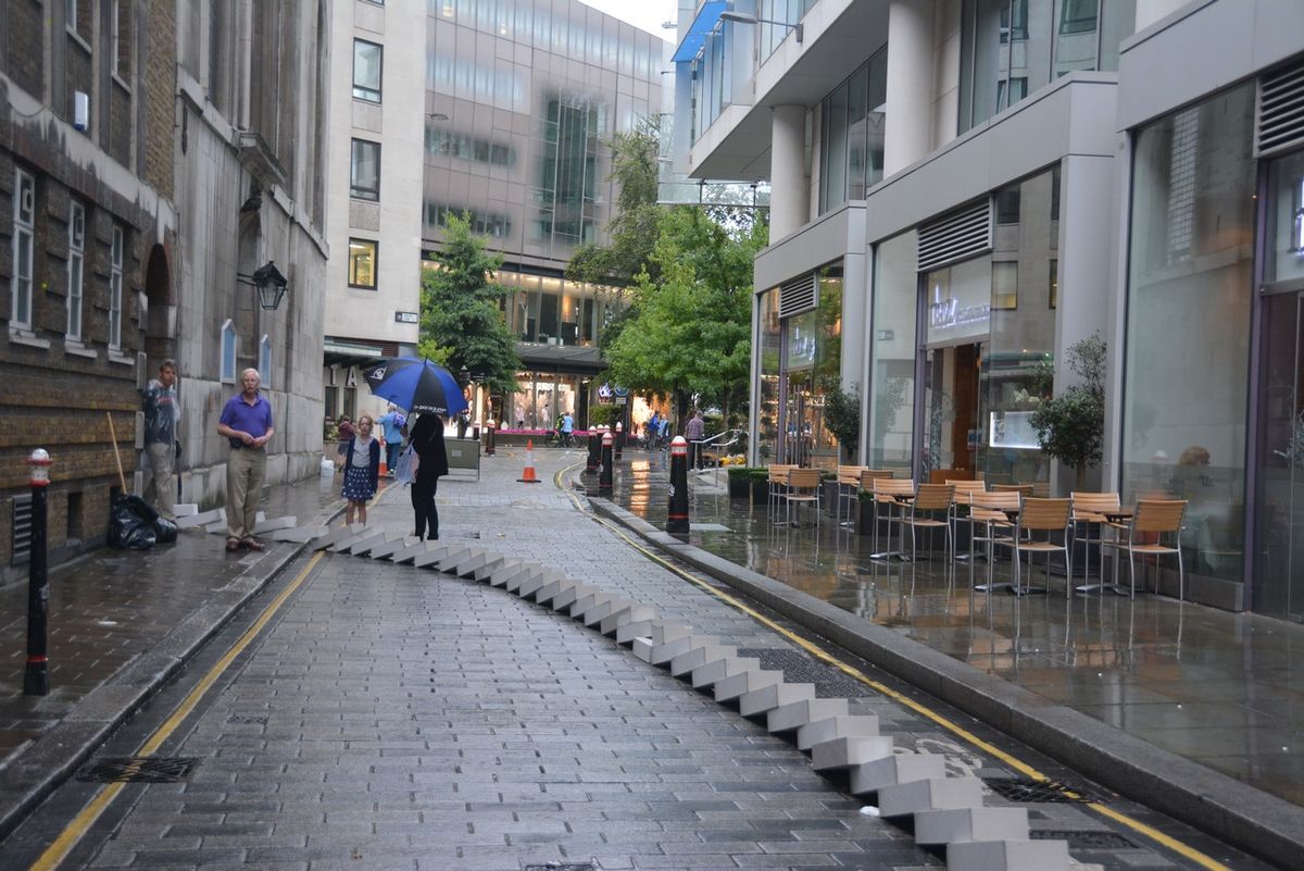 Fallen white blocks stretching along a city street.