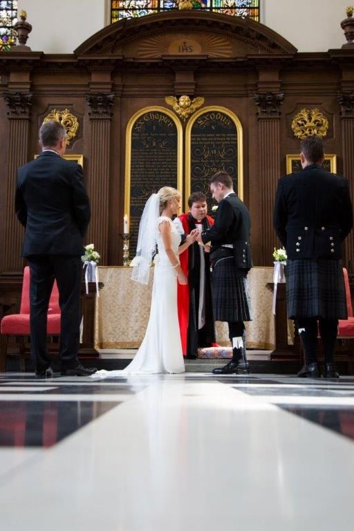 A wedding ceremony seen from a low viewpoint along the patterned floor.